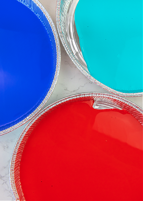 three foil tins of blue aqua and red paint