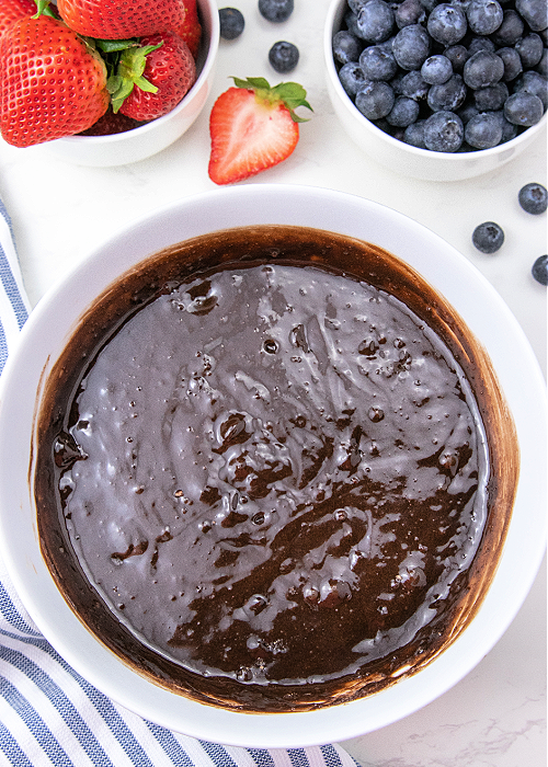 4th of July Brownie Bites are a colorful dessert for all your patriotic parties! Red, white, and blue with strawberries and blueberries! brownie batter in a white mixing bowl