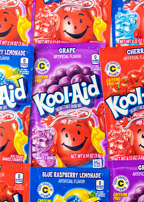 This Whipped Kool-Aid for kids is the perfect indoor activity when it's too hot outside. Or make it as a surprise treat! Children love it! kool aid packets in purple, blue and red
