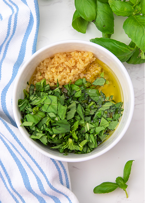 olive oil, minced garlic, and chopped fresh basil in a small ingredient bowl