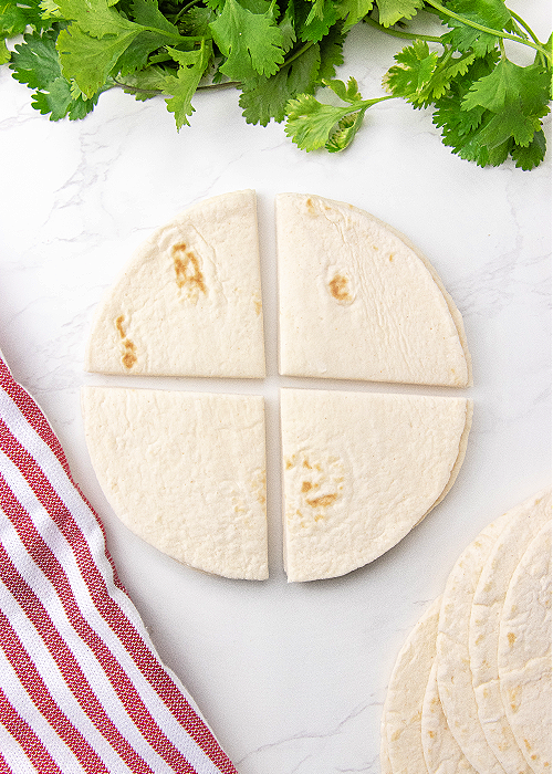 step by step instructions for taco cups a tortilla cut into four quadrnts