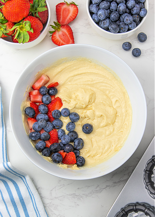 These Blueberry Strawberry Shortcakes are so flavorful, refreshing, light and perfect for all of your patriotic summer parties! white mixing bowl with blueberry strawberry shortcake inside
