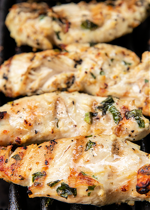 chicken tenderloins grilling on a grill