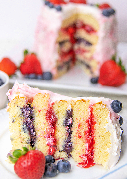 a slice of patriotic berry cake on a white plate