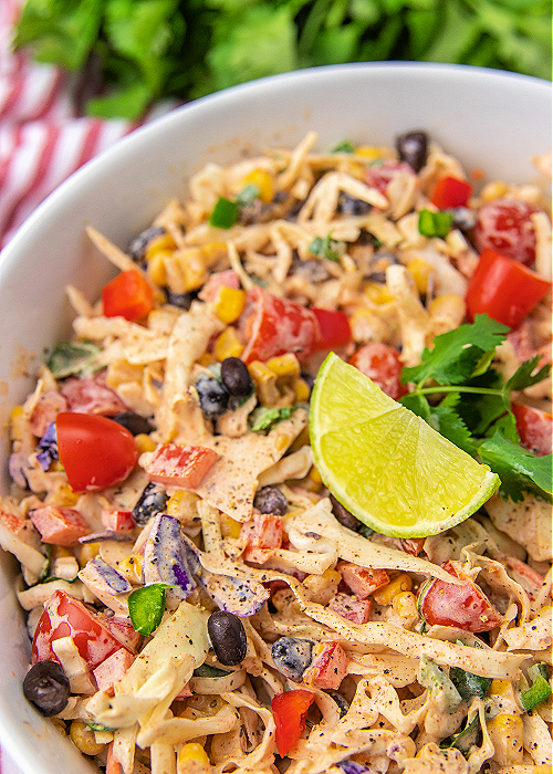 easy mexican coleslaw garnished with lime and cilantro