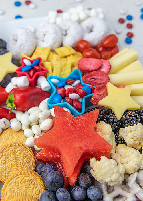 kid-friendly 4th of july snack board with red white and blue foods