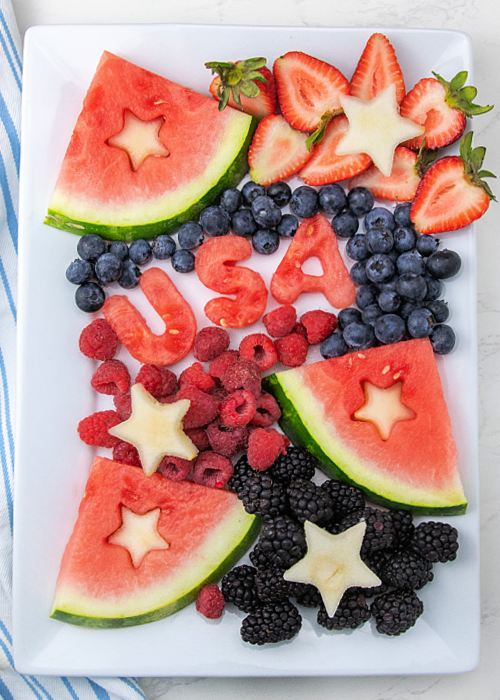 usa fruit platter with a blue striped towel next to it