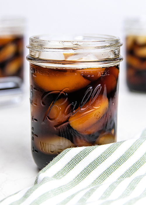 This Starbucks Sweet Cream Cold Foam Copycat recipe has the texture and flavor of the real thing! A hint of sweetness and SO refreshing! iced coffee in a mason jar with a striped napkin