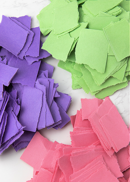 three piles of torn construction paper