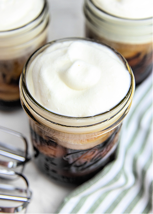 This Starbucks Sweet Cream Cold Foam Copycat recipe has the texture and flavor of the real thing! A hint of sweetness and SO refreshing! starbucks copycat cold foam drink in a mason jar with a striped napkin