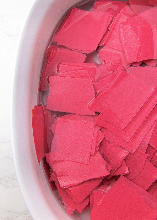 squares of paper soaking in water