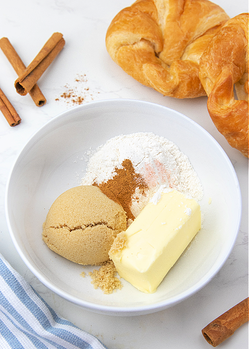 French Toast Muffins are delicious and easy to bake! Cinnamon and croissants combine for mega flavor in a convenient muffin-size serving! streusel topping before mixing