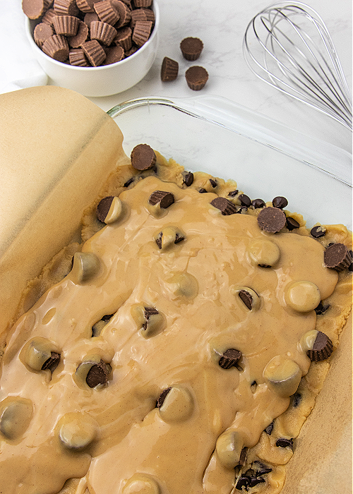 gooey peanut butter drizzled over cookie bars before baking