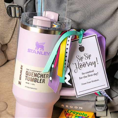 purple stanley mug for a first day of school teacher gift with a free printable tag