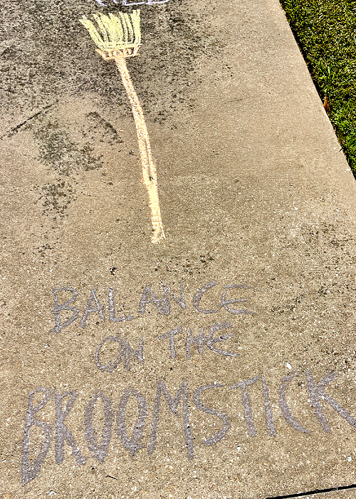 balance on the broomsticks