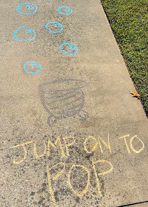 jump on the cauldron bubbles to pop halloween chalk obstacle course