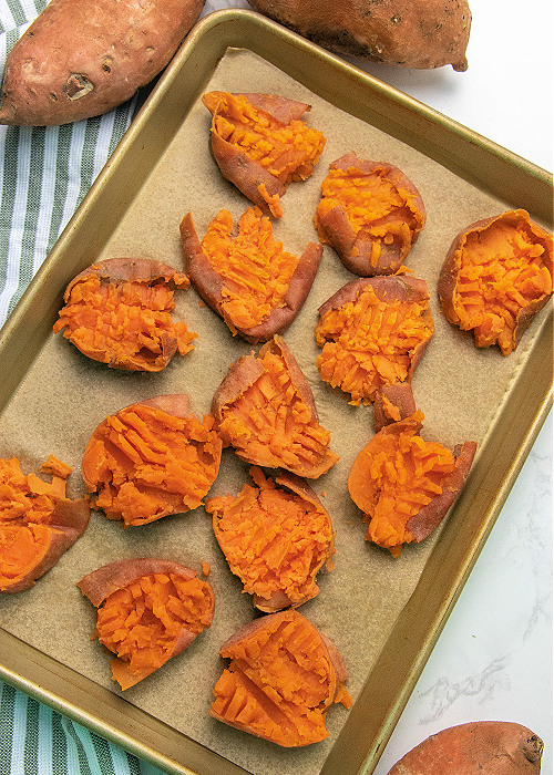 These Garlic Parmesan Smashed Sweet Potatoes are the perfect modern addition to your Thanksgiving meal or any dinner, for that matter! garlic parmesan smashed sweet potatoes