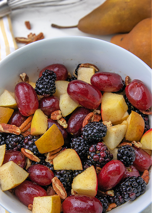 fall fruit salad in a white serving bowl