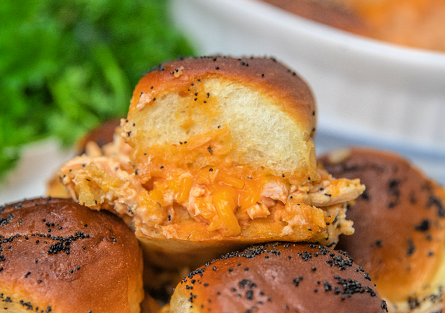 buffalo chicken sliders with poppy seeds on top