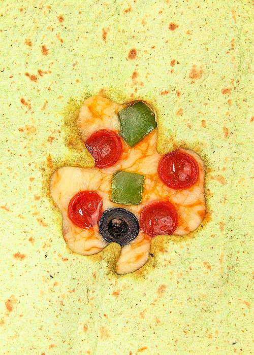 pizza quesadilla with a shamrock cut out of the top tortilla with a cookie cutter