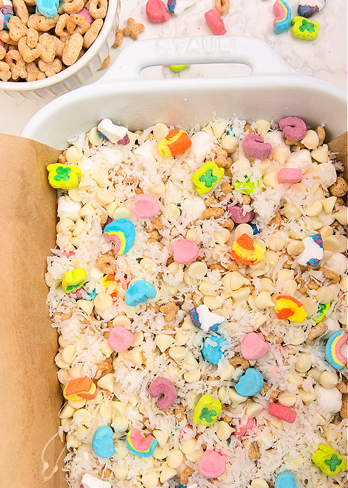 These Lucky Charms Magic Cookie Bars combine cereal with a classic! Perfect for St. Patrick's Day, this dessert is easy to make and looks festive, too! lucky charms magic cookie bars before baking