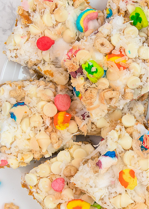These Lucky Charms Magic Cookie Bars combine cereal with a classic! Perfect for St. Patrick's Day, this dessert is easy to make and looks festive, too! lucky charms magic cookie bars recipe