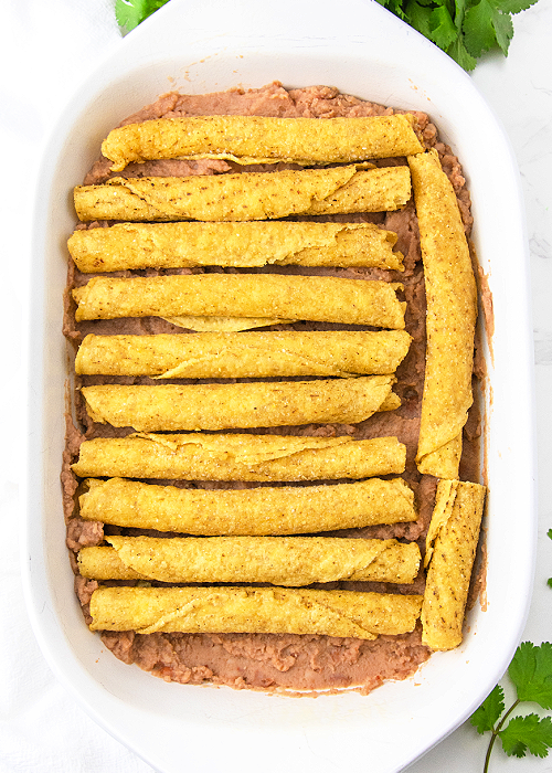 step by step photo of lazy enchilada casserole made with frozen taquitos