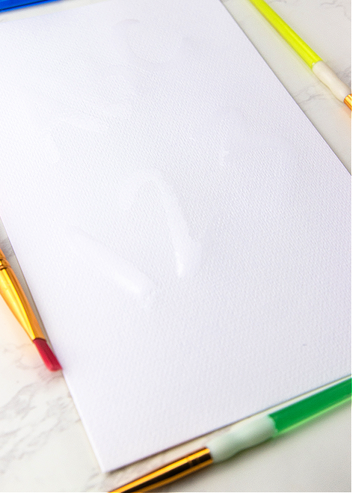 This No-Heat Invisible Ink Activity for Kids combines several common household items and works perfectly with BRIGHT color every time! a design written in invisible ink on a white piece of paper