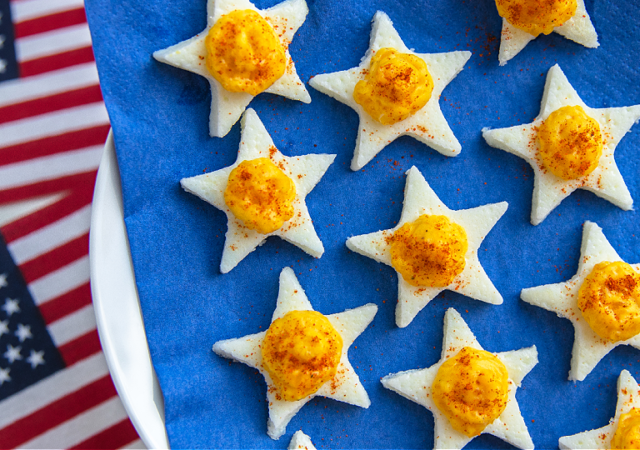 patriotic deviled eggs in a star shape on a blue napkin