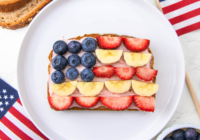 flag toast on a white plate with blueberries and strawberries