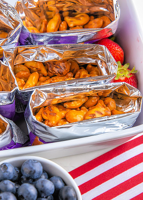 step by step image of walking pretzel salad showing pretzel goldfish in the bottom of individual snack bags