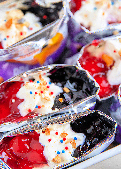 red white and blue walking pretzel salad packages in a white serving container