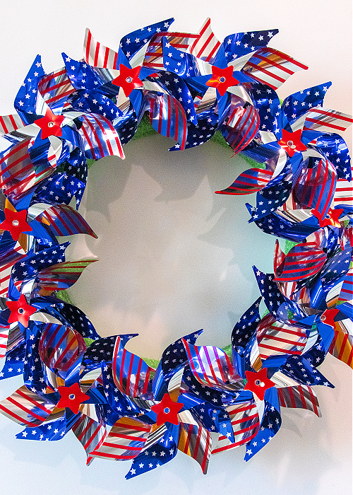 patriotic pinwheel wreath made out of red white and blue pinwheels