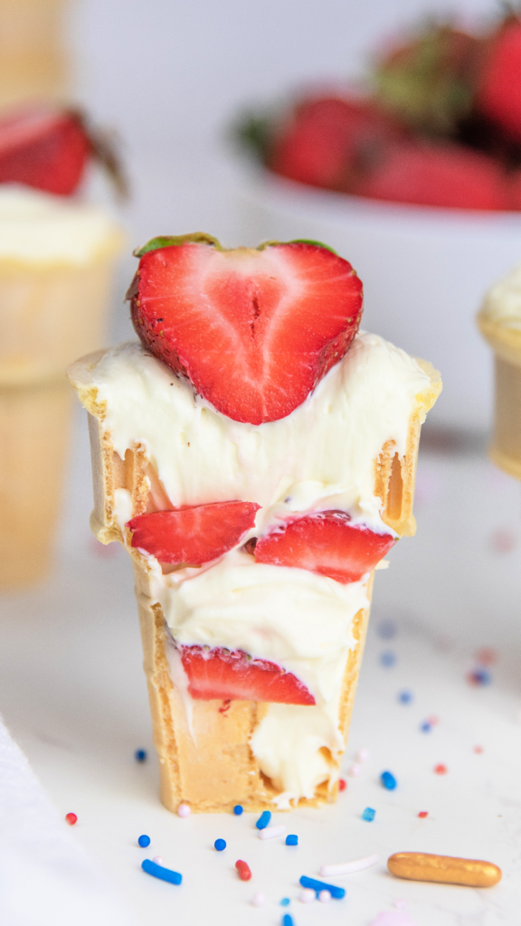 strawberries and layered cheesecake in a cone