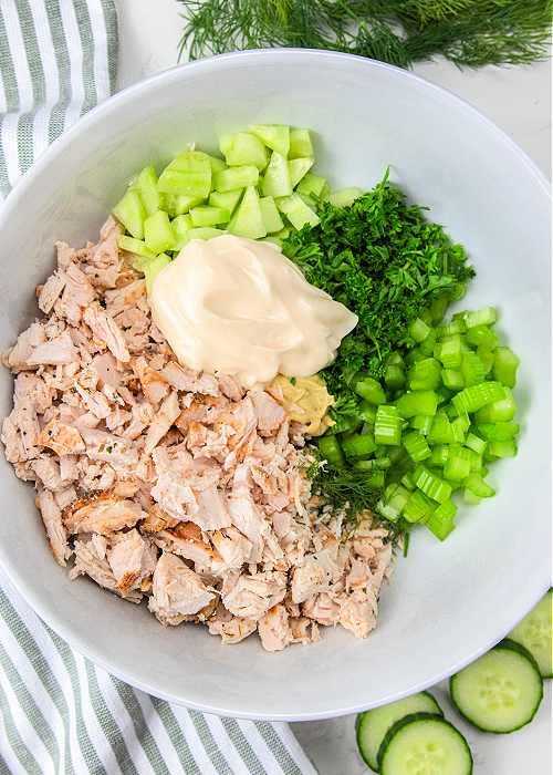 ingredients in a bowl for cucumber dill chicken salad
