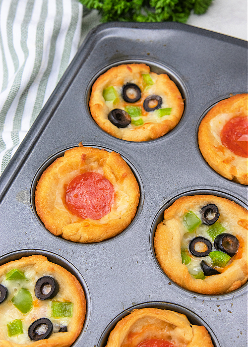 baked mini pizzas in a muffin tin