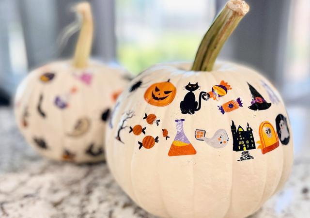 white pumpkin with children's halloween temporary tattoos on it for decoration