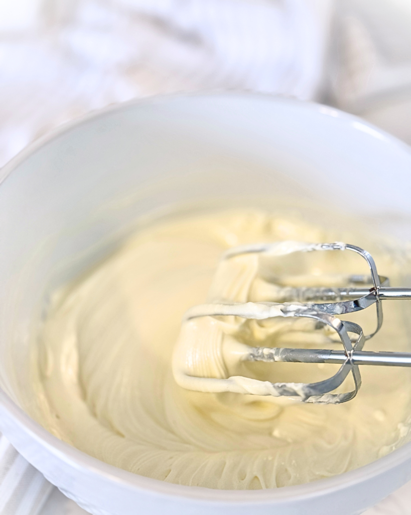 mixing 3 ingredient cheesecake in a mixing bowl