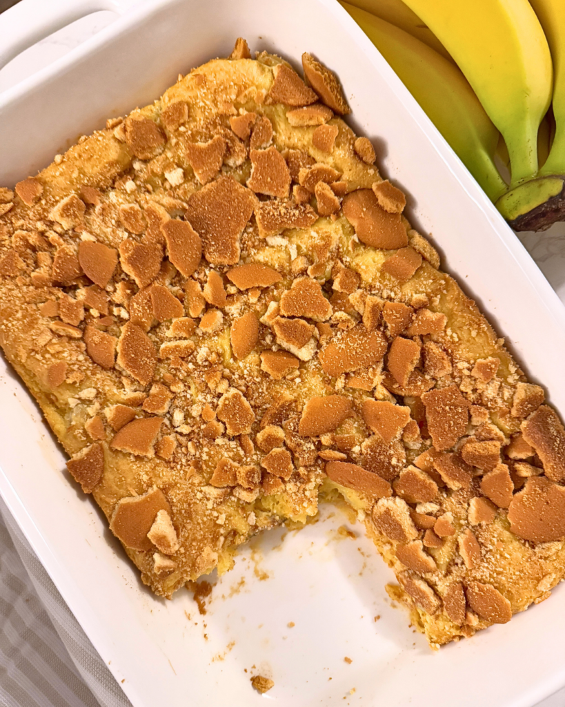 banana pudding brownies in a serving tray with a piece removed
