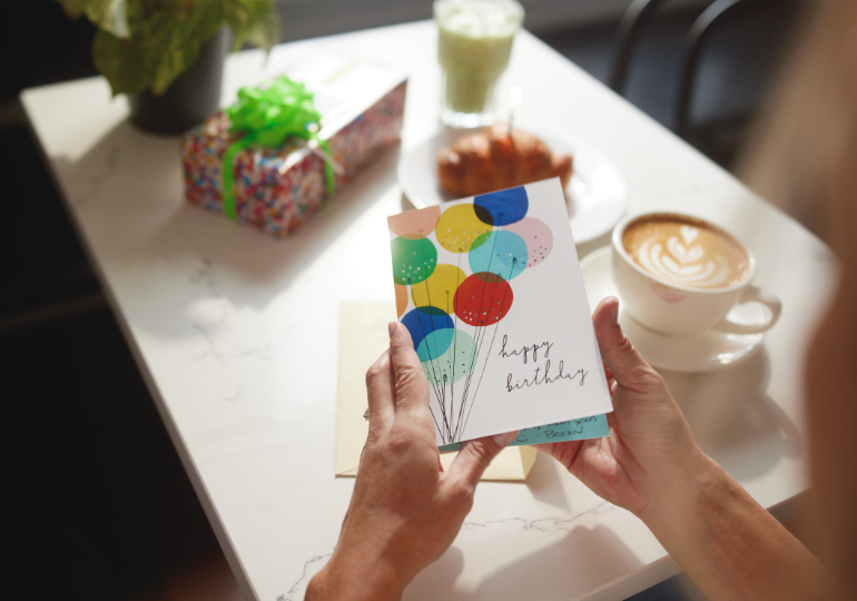 someone holding a greeting card from the hallmark bogo sale 2026
